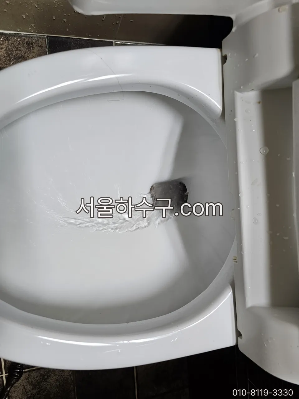 부속 교체 후 물을 채워 내려 보며 시험하는 모습