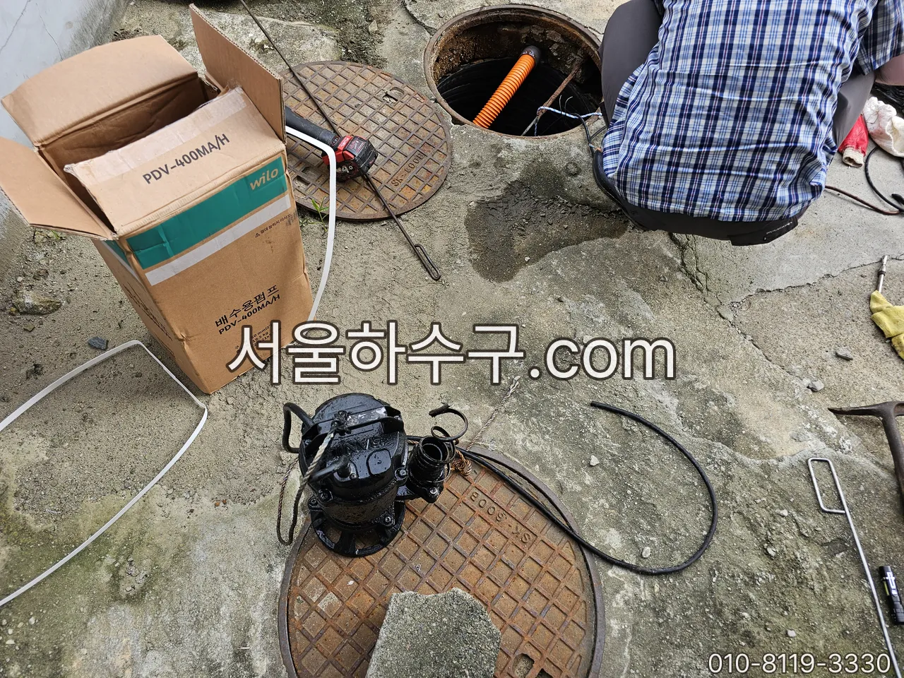 새 수중펌프와 교체 전 펌프를 나란히 놓고 확인하는 장면
